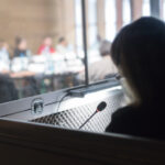 woman translating in translators cubicle